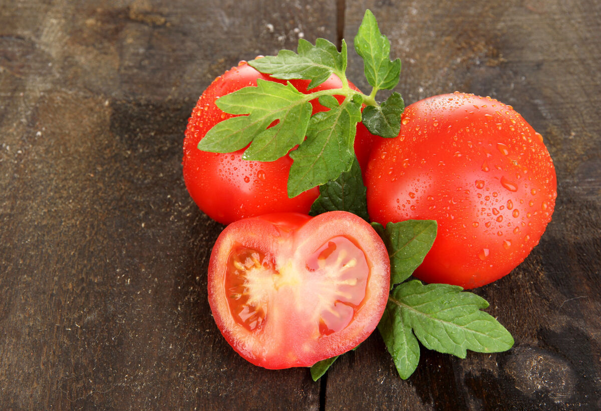 新新鲜的西红柿放在木桌上生活叶子吃