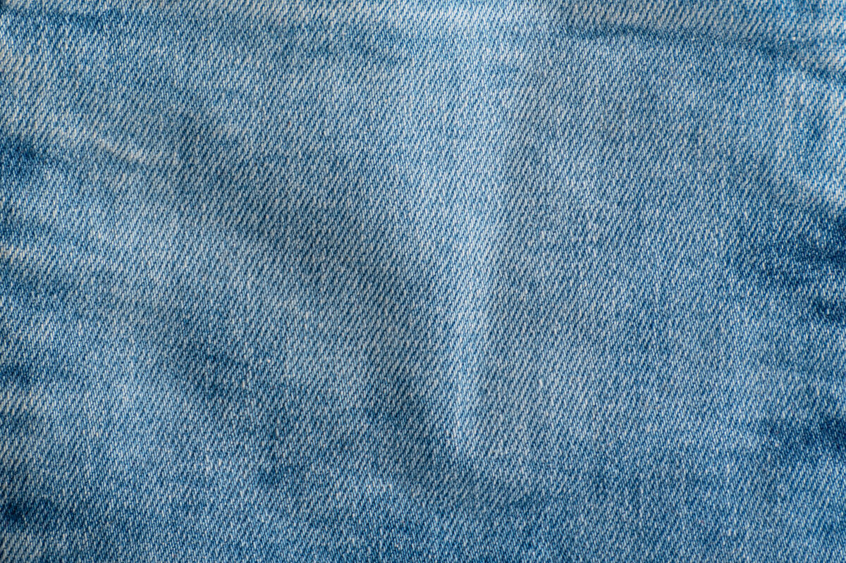 面料牛仔裤质地贴身up.纺织品背景：牛仔布蓝色城市Costura传统