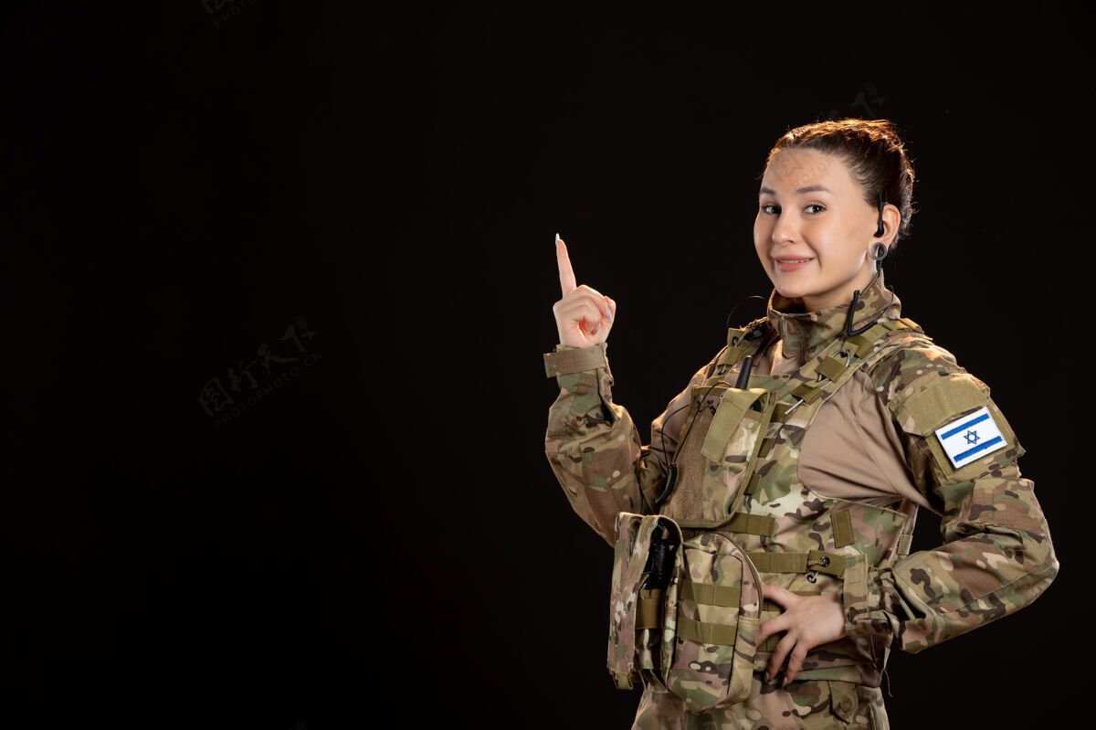 肖像黑墙上穿迷彩服的女兵制服战争女性