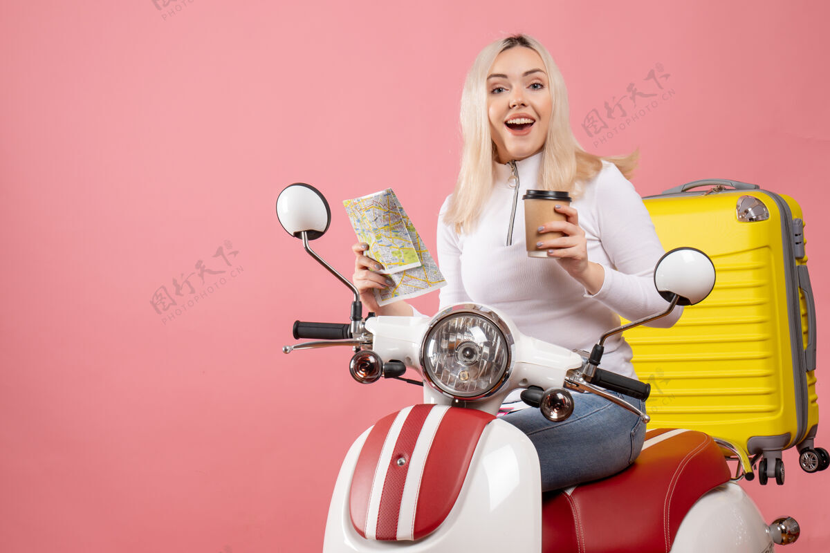 漂亮前面的景色把那个骑着轻便摩托车 提着黄色手提箱的年轻女士难住了坐着手提箱摩托车