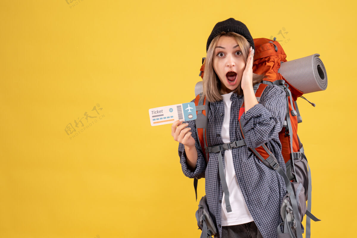 时尚前视图惊讶的旅行妇女背着背包拿着票人背包票