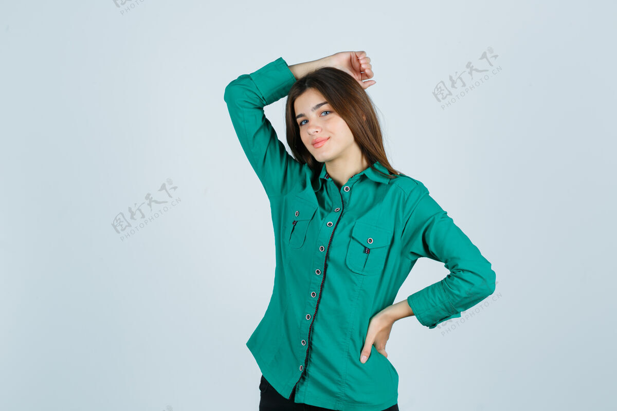 室内照片中的年轻女性手挽着手 头戴绿色衬衫 正面看起来很欢快现代墙黑发