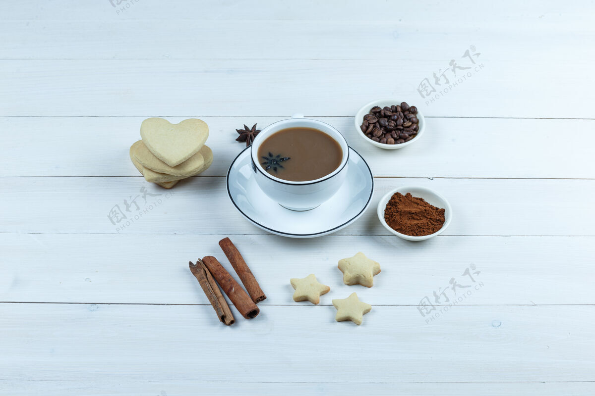 质地一套饼干 香料 咖啡豆 磨碎的咖啡和咖啡在一个木制背景上的杯子高角度视图豆子咖啡因自然
