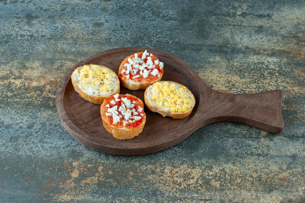 餐木板上夹果酱的新鲜白面包片果酱好吃木板