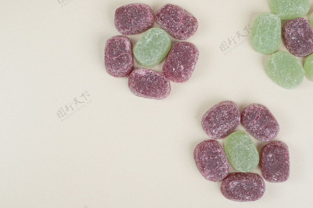 甜点绿色和紫色果冻糖果米色表面明胶果冻美味