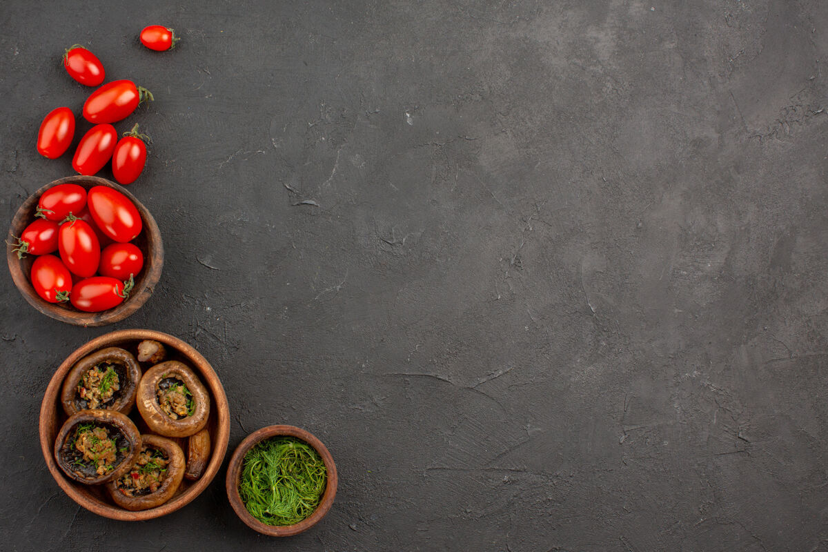 意大利面顶视图煮熟的蘑菇和西红柿在黑暗的桌子上蘑菇野生面食西红柿蘑菇食物