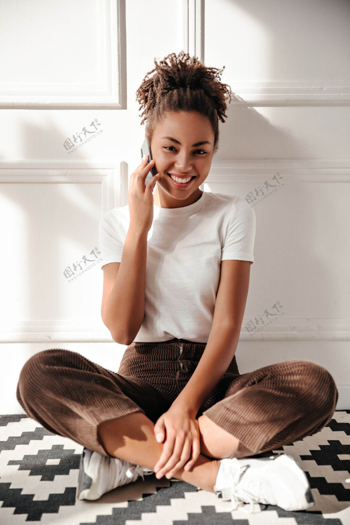 年轻人高兴的年轻女子在智能手机上说话休闲欢呼积极