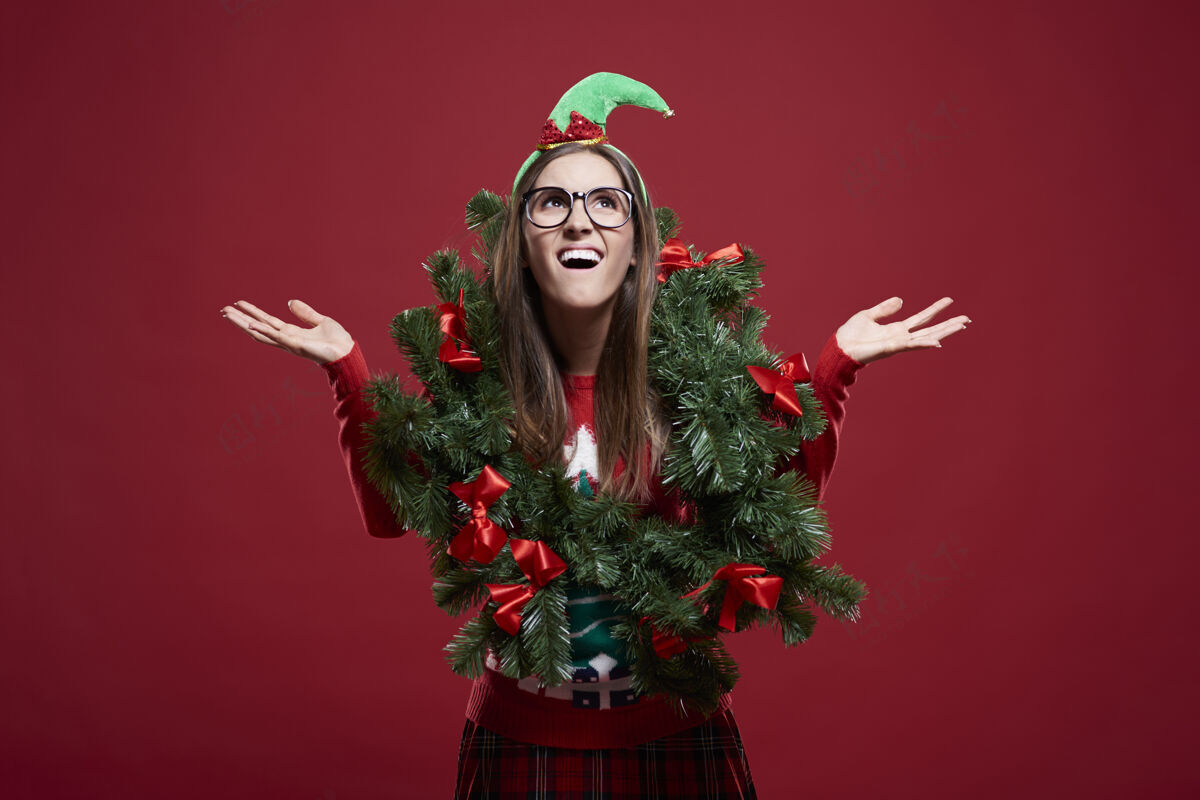玩戴着圣诞花环的滑稽女人问题圣诞树张开嘴