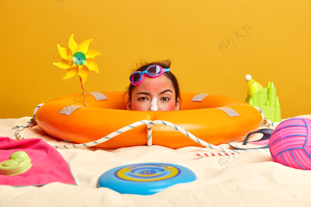 模型年轻女子头上涂着防晒霜 脸上围着沙滩饰品健康头部休息