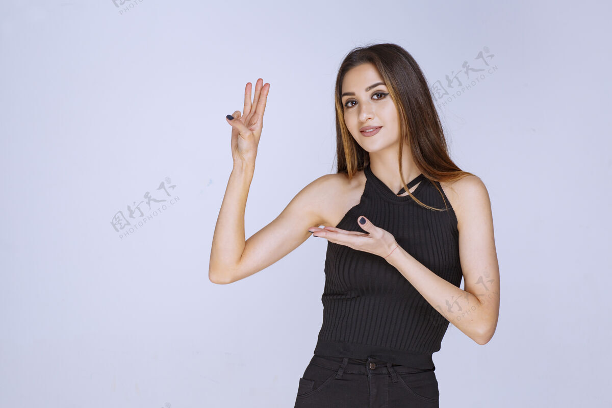 成人穿黑衬衫的女人张开双手做演讲表演场景年轻人