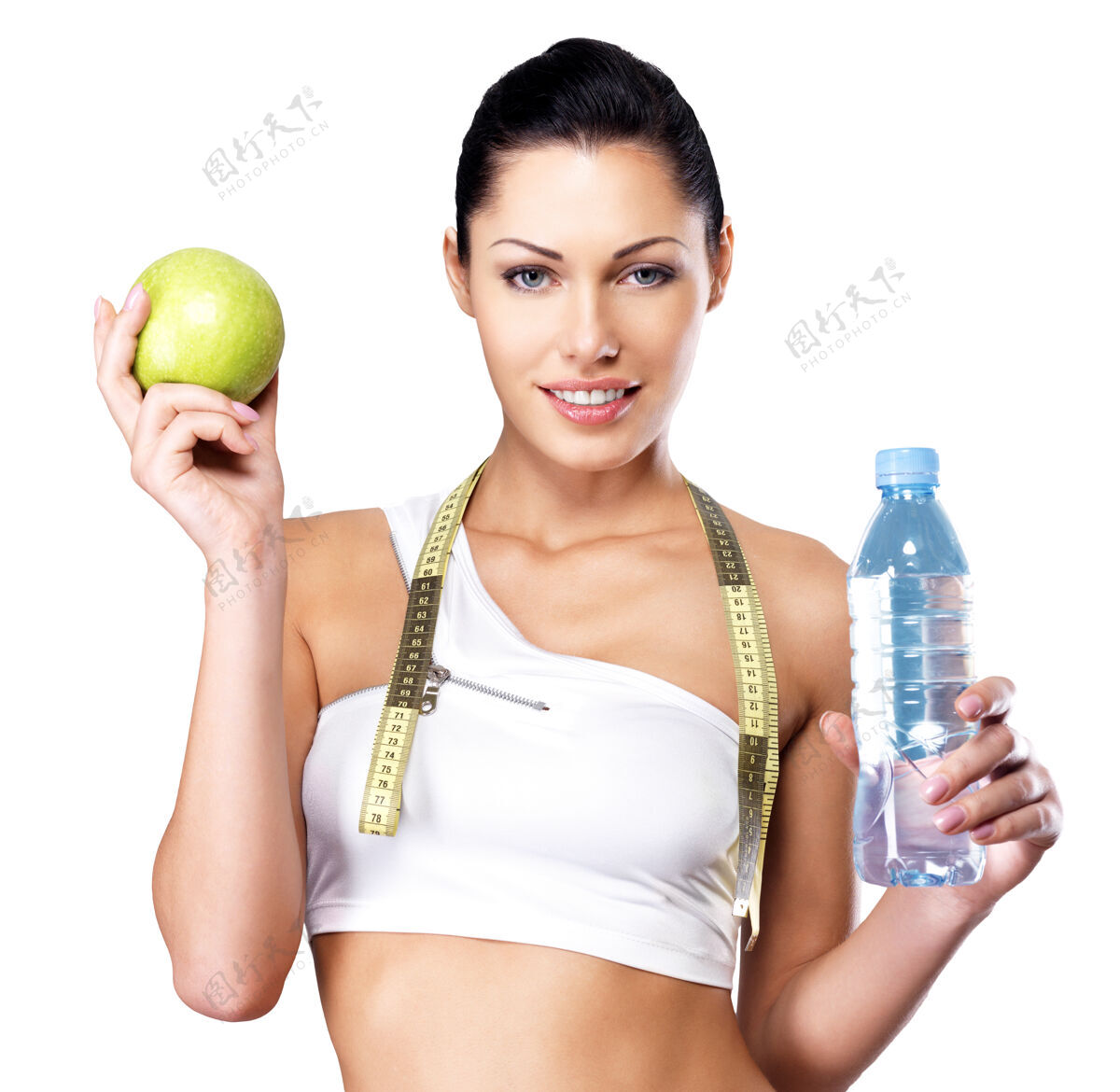 女性一个健康女人拿着苹果和一瓶水的画像饮料训练锻炼