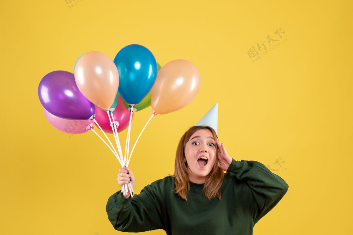 情感正面图：手持彩色气球的年轻女性乐趣气球女性