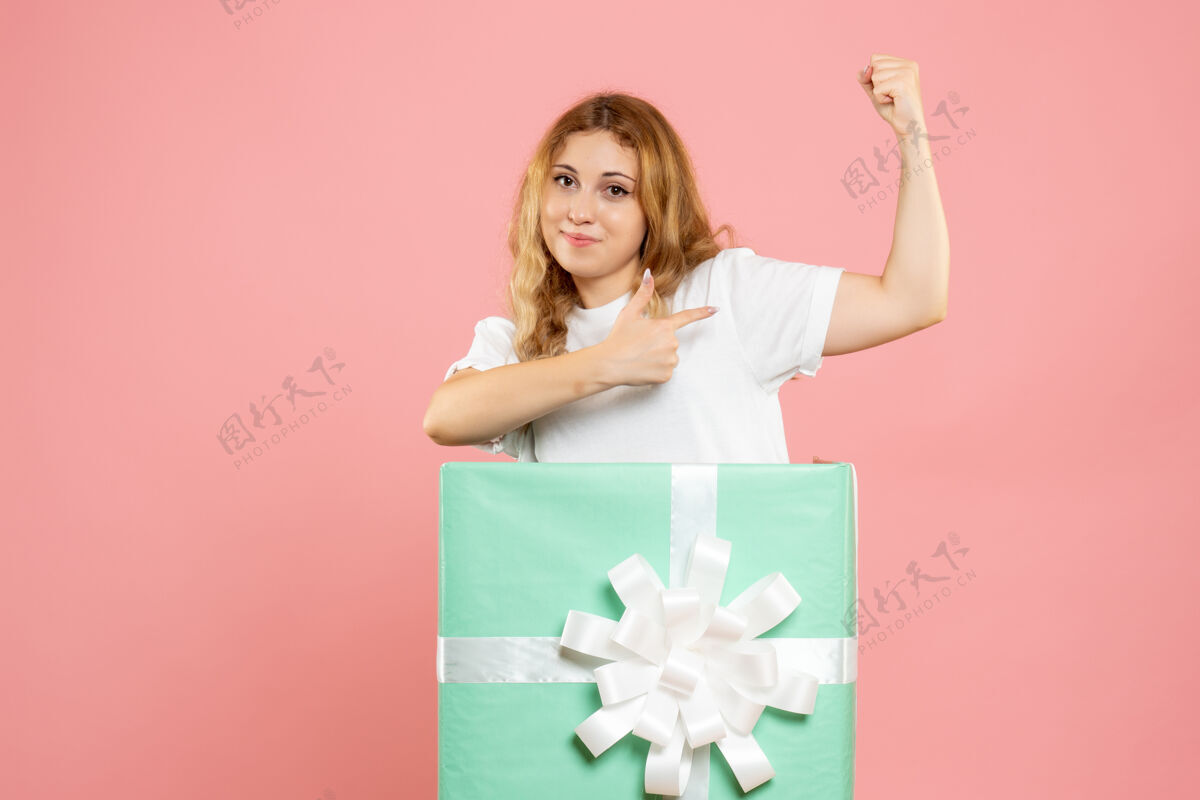 颜色正面图蓝色礼品盒内的年轻女性圣诞蓝色礼物