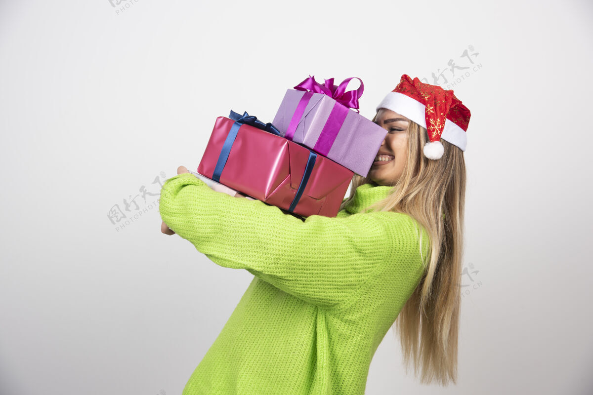 女性年轻微笑的女人手里拿着圣诞礼物帽子年轻人女孩