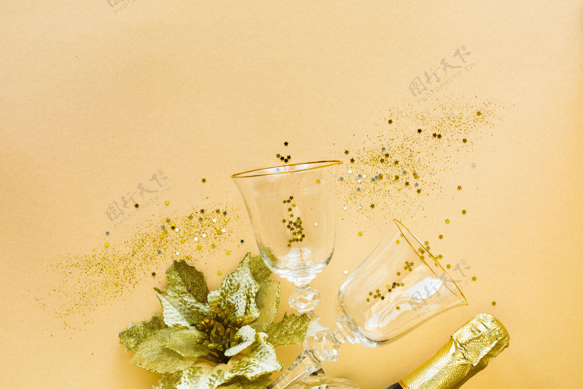 年平铺的庆祝两杯香槟和礼物的黄色背景玻璃杯节日平底