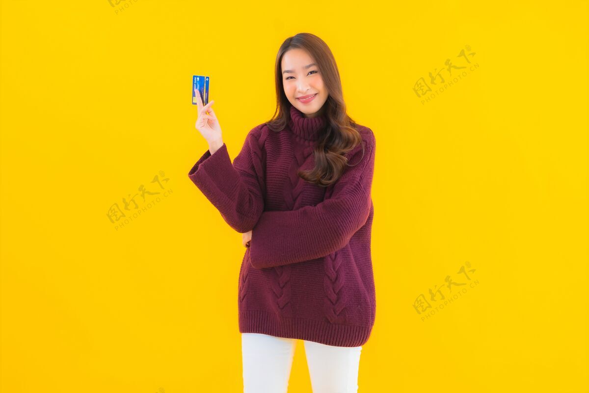 消费主义肖像美丽的亚洲年轻女子用信用卡进行网上购物兴奋购买五颜六色