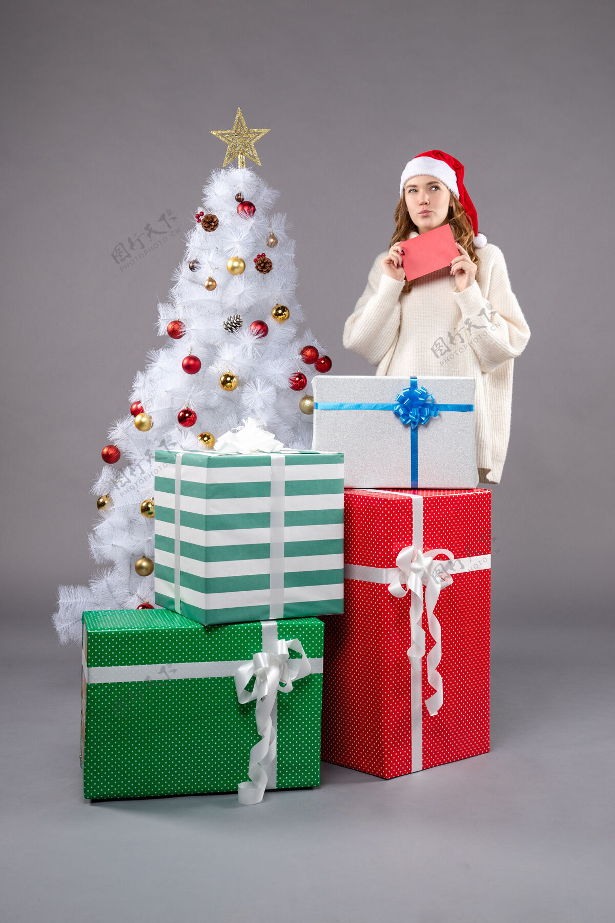 圣诞帽拿着信封的年轻女人女圣诞圣诞老人