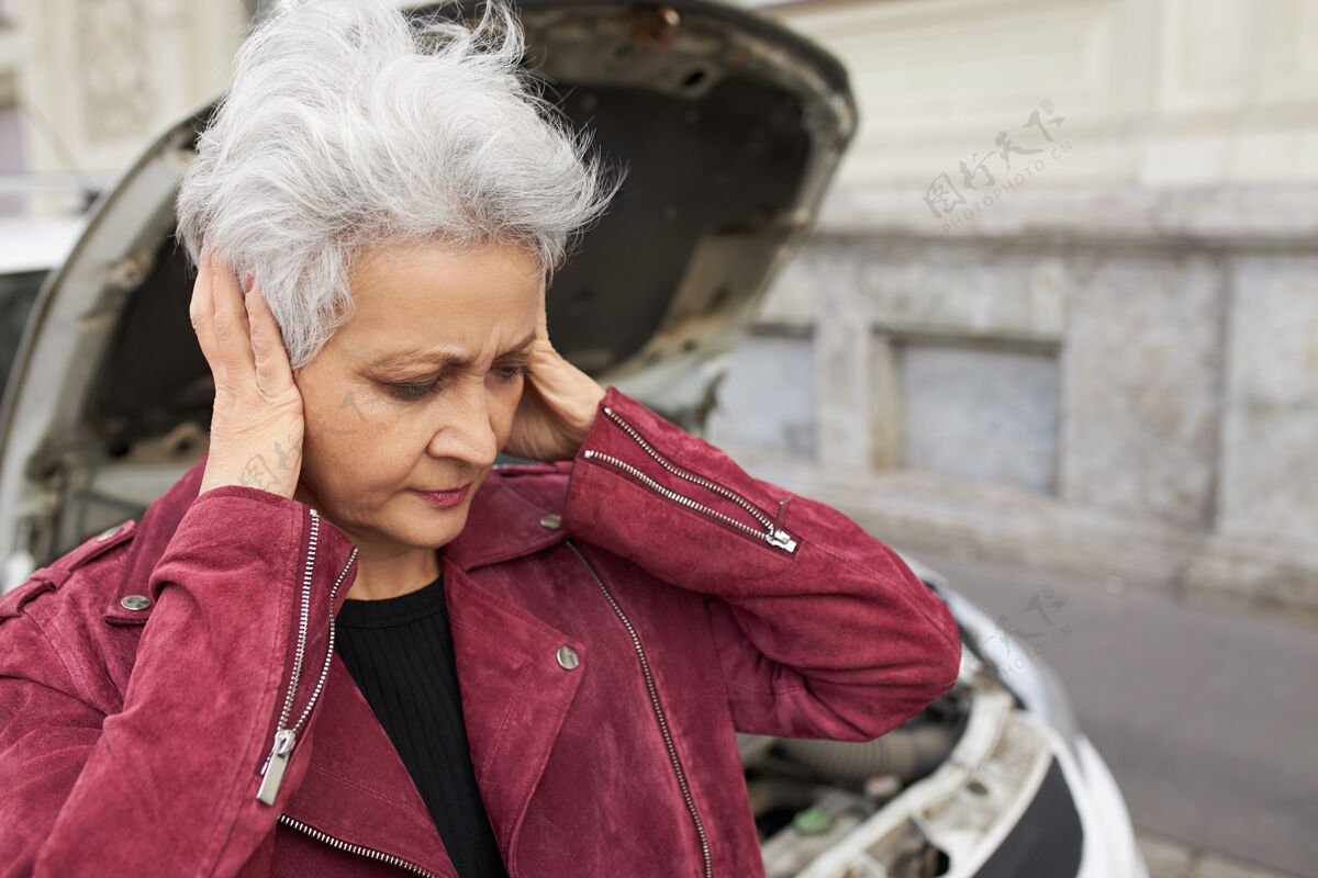 无助一张户外照片 照片上是一位心情不好的退休女性 灰色短发遮住耳朵 因为她的车坏了而感到沮丧妇女女性麻烦